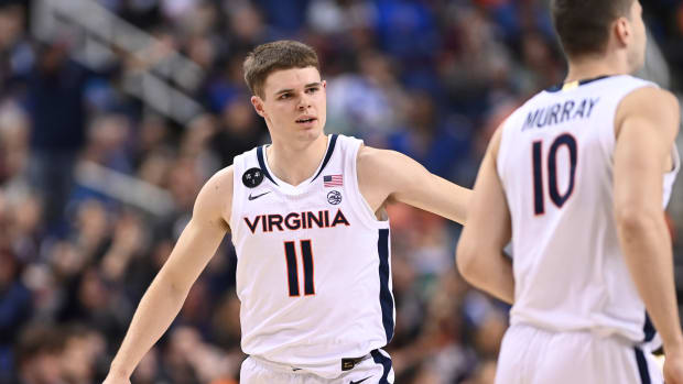 Virginia Cavaliers guard Isaac McKneely (11) reacts with guard Taine Murray (10) in the first half during the semifinals of the ACC Tournament at Greensboro Coliseum.